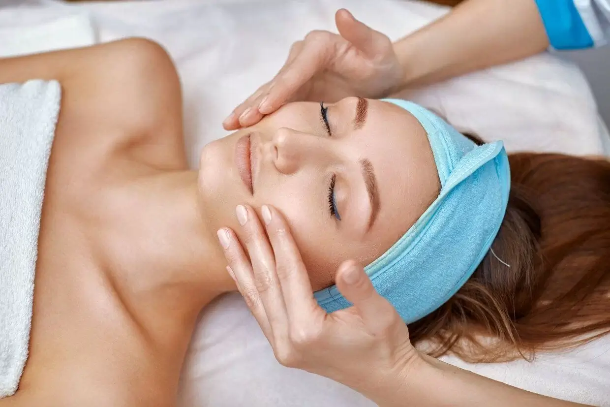 Lady Wearing A Headband And Receiving Collagen Boosting Treatments